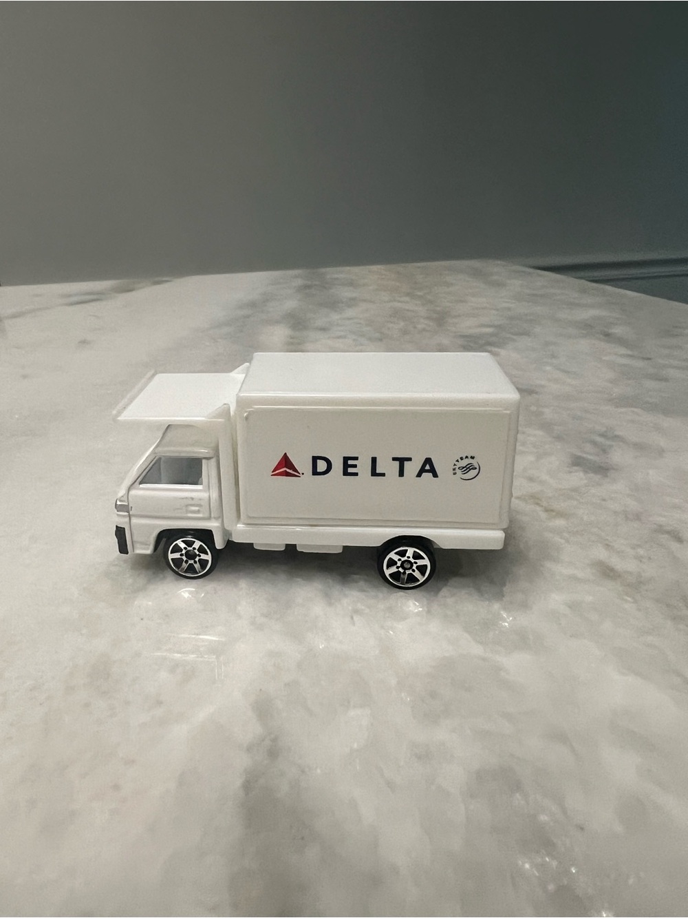 Delta White Mini Delivery Truck Toy with Red Logo